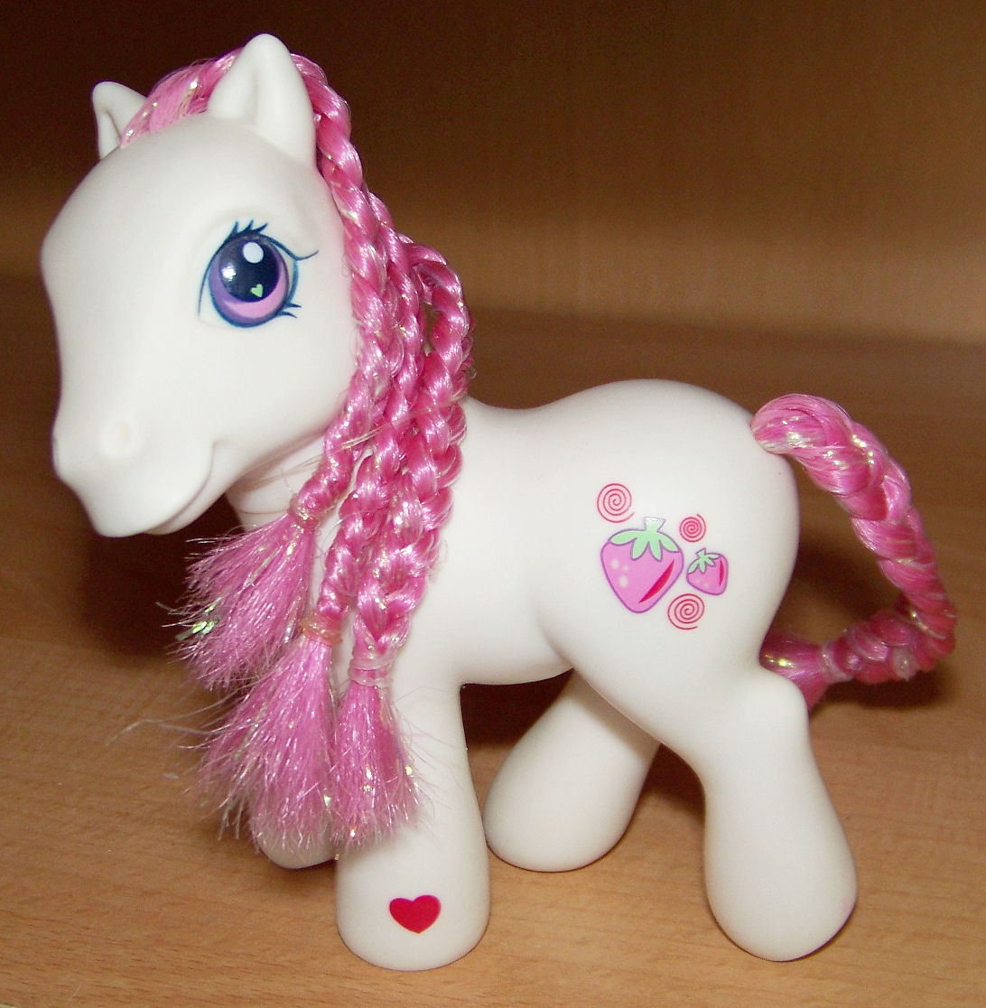 a small toy pony with long pink mane and heart shaped eyes