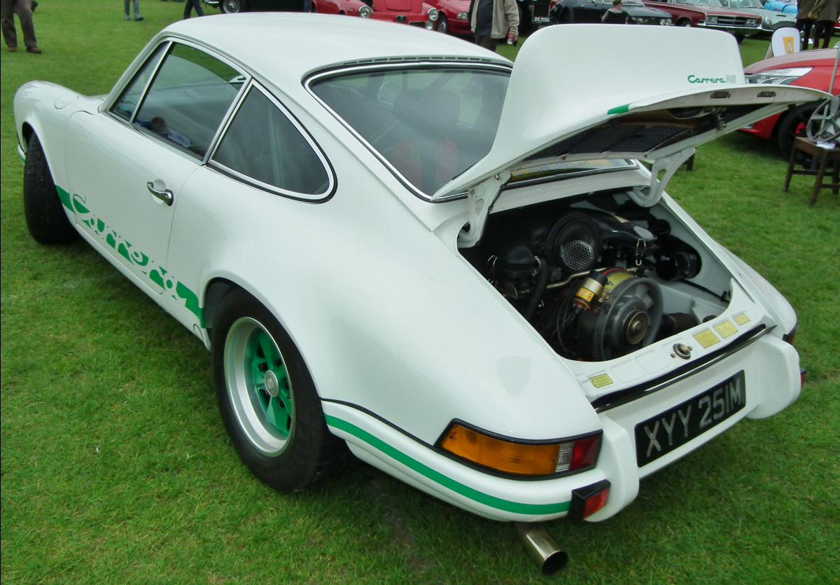 a white sports car that has its hood up