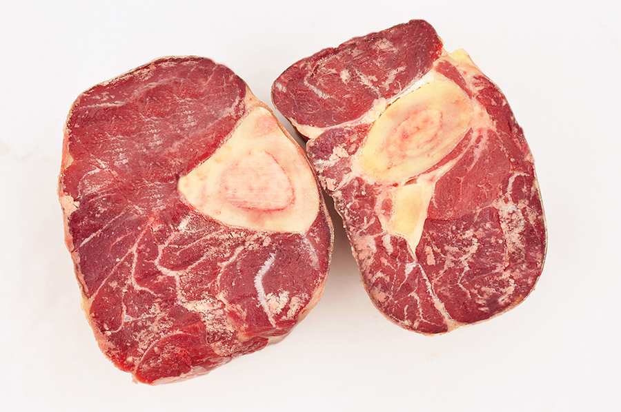 two pieces of meat are shown on a white background
