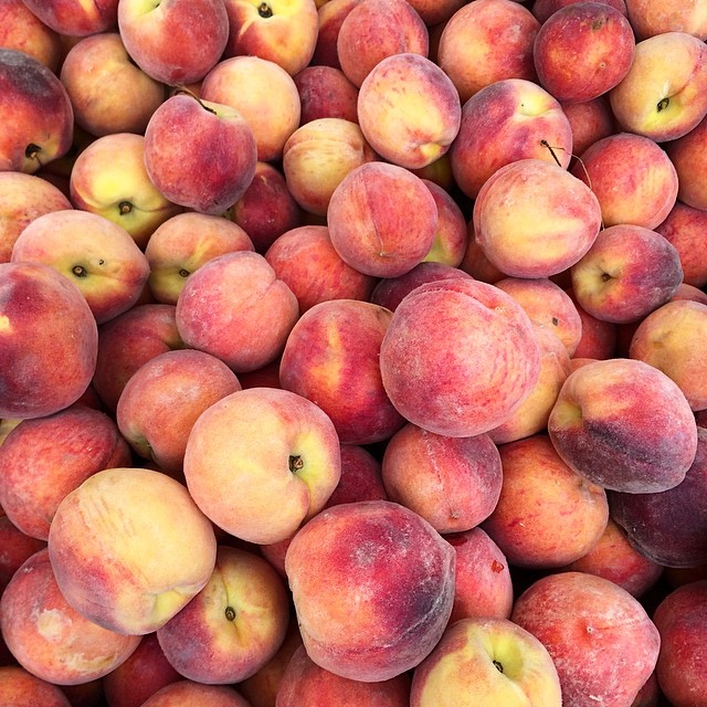 an image of fresh peaches piled high for sale