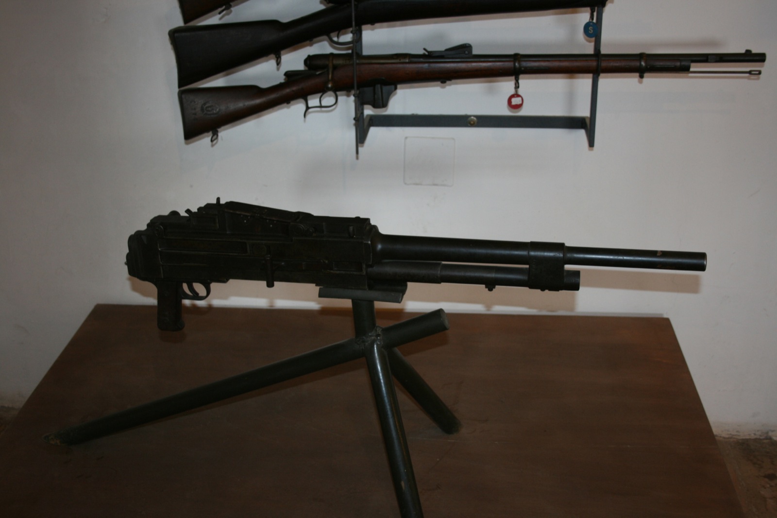 a rifle that is standing up on a table