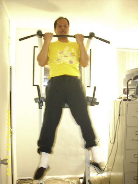 a man performing pullups in a living room