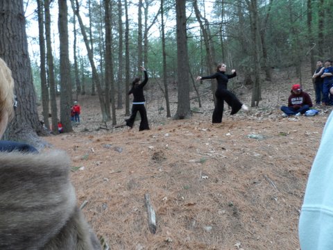 a group of people are in the woods practicing martial