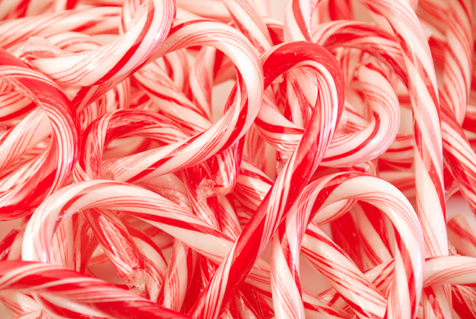 candy canes lined up and arranged in the shape of hearts