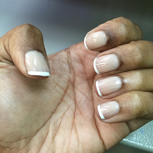 hand with clear nails with white french manies
