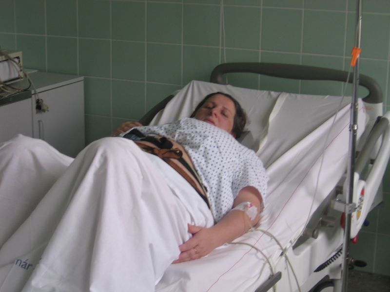 woman laying on top of a medical bed in a hospital