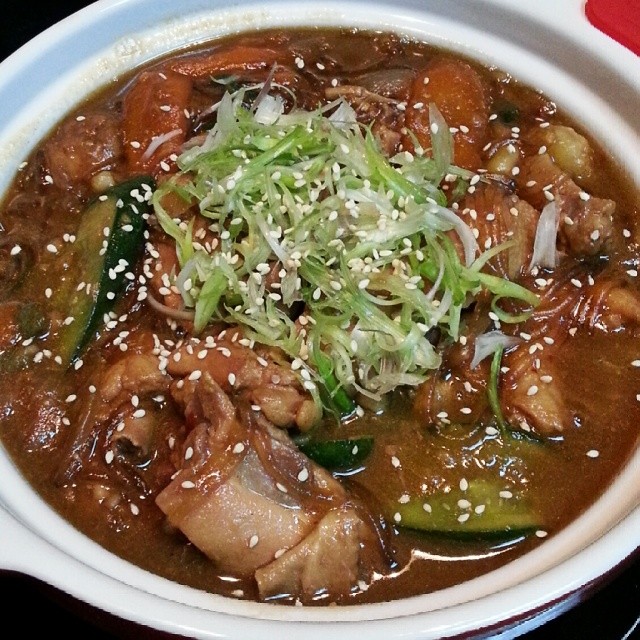 the bowl of soup has an assortment of meats and vegetables