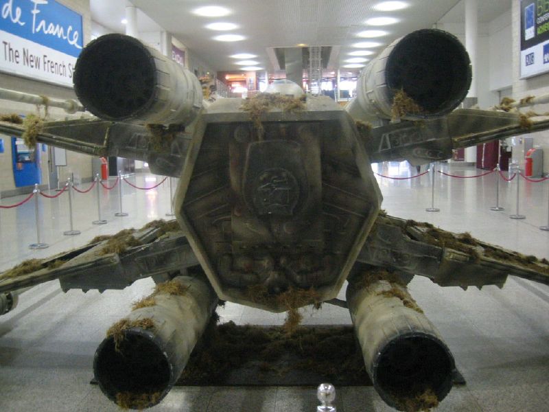 the rear end of an airplane with pipes attached to it