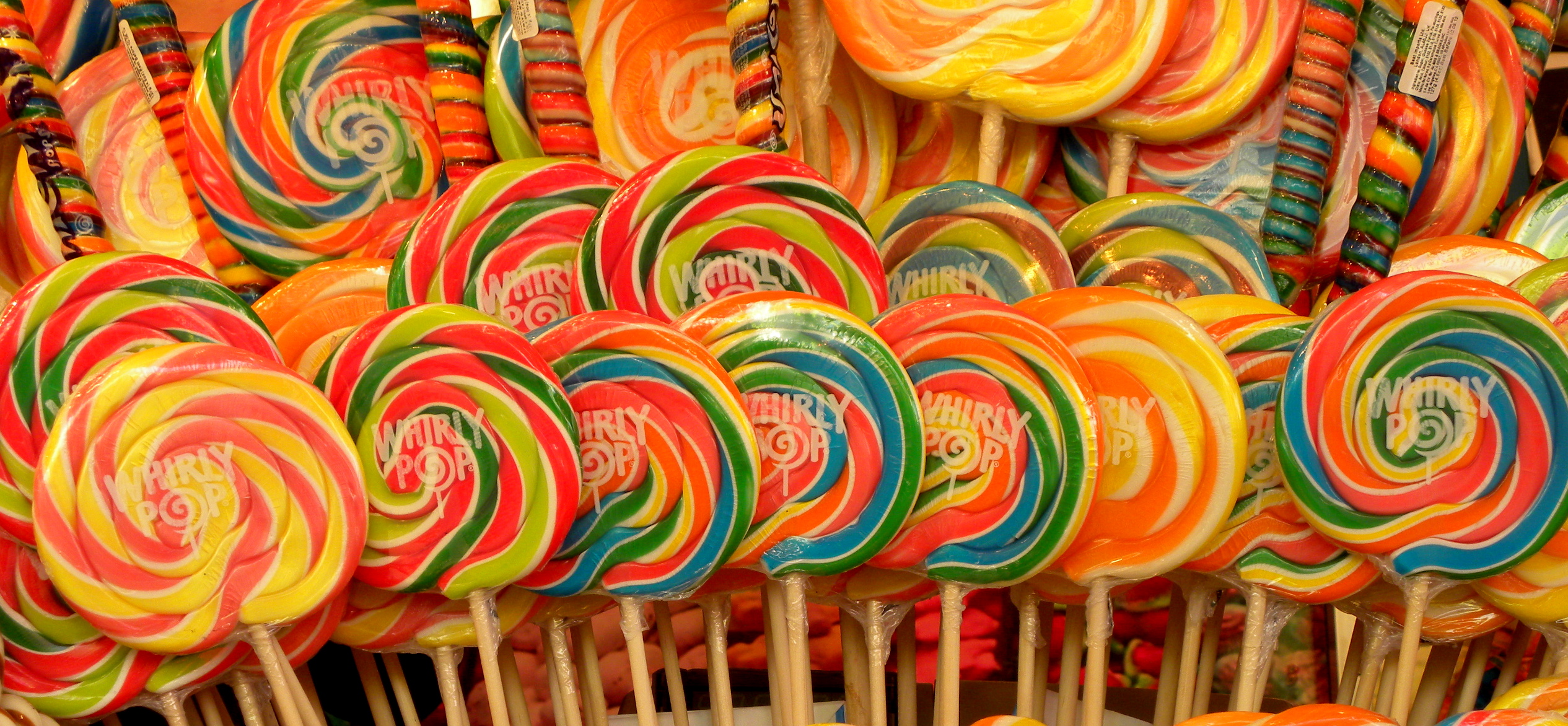 a display of many colorful candy lollipops on sticks