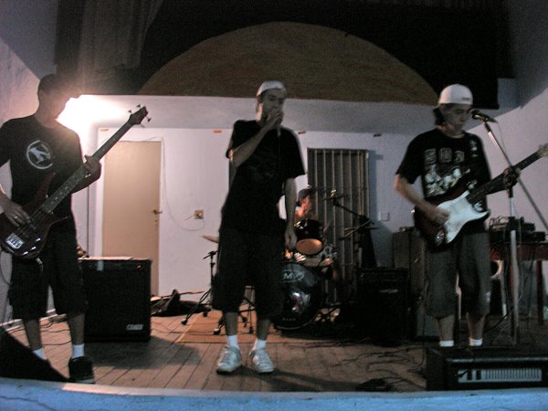 a band performing on stage in a small house