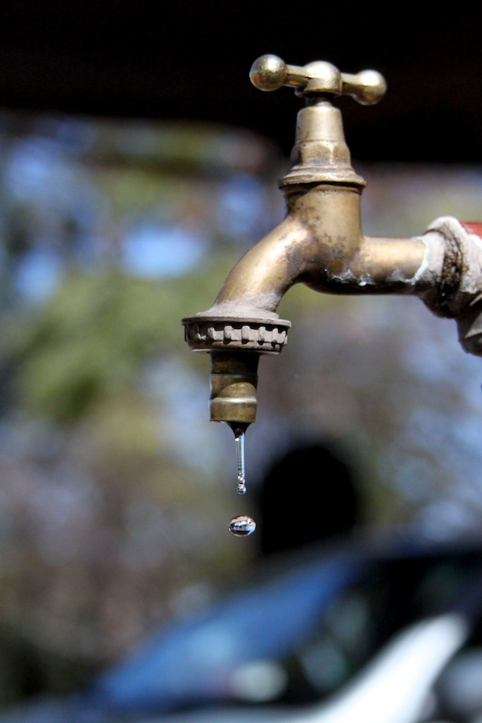 a close up of a faucet with a water dripping from the tap