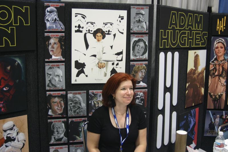 a woman in front of her poster display