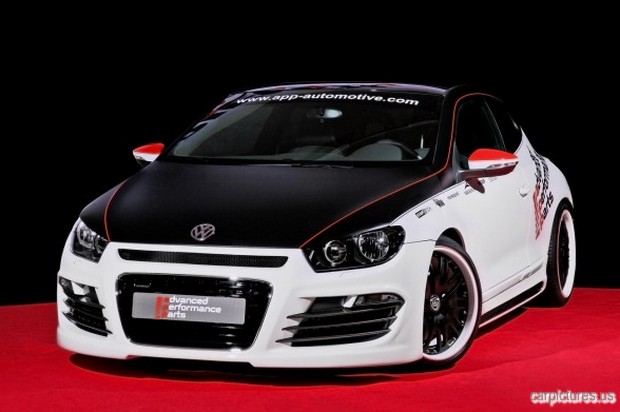 a white and black car sitting on top of a red carpet