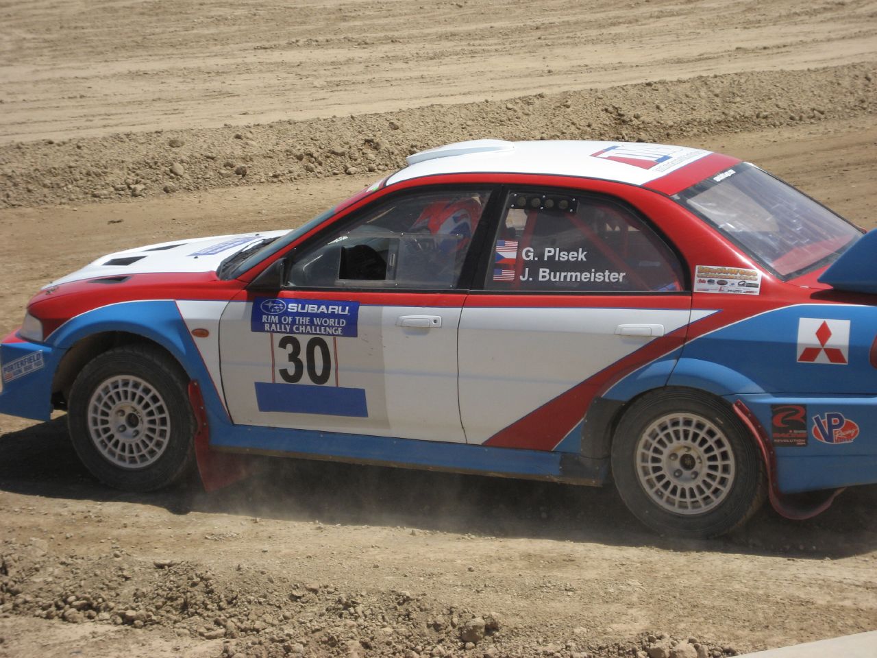 a car in action on a dirt track