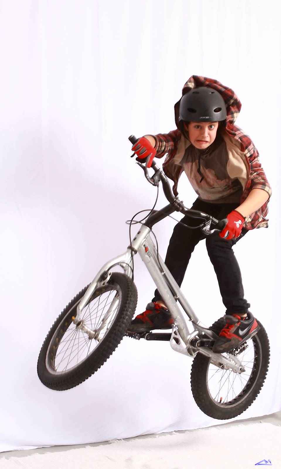 young man performing stunt on bicycle with helmet