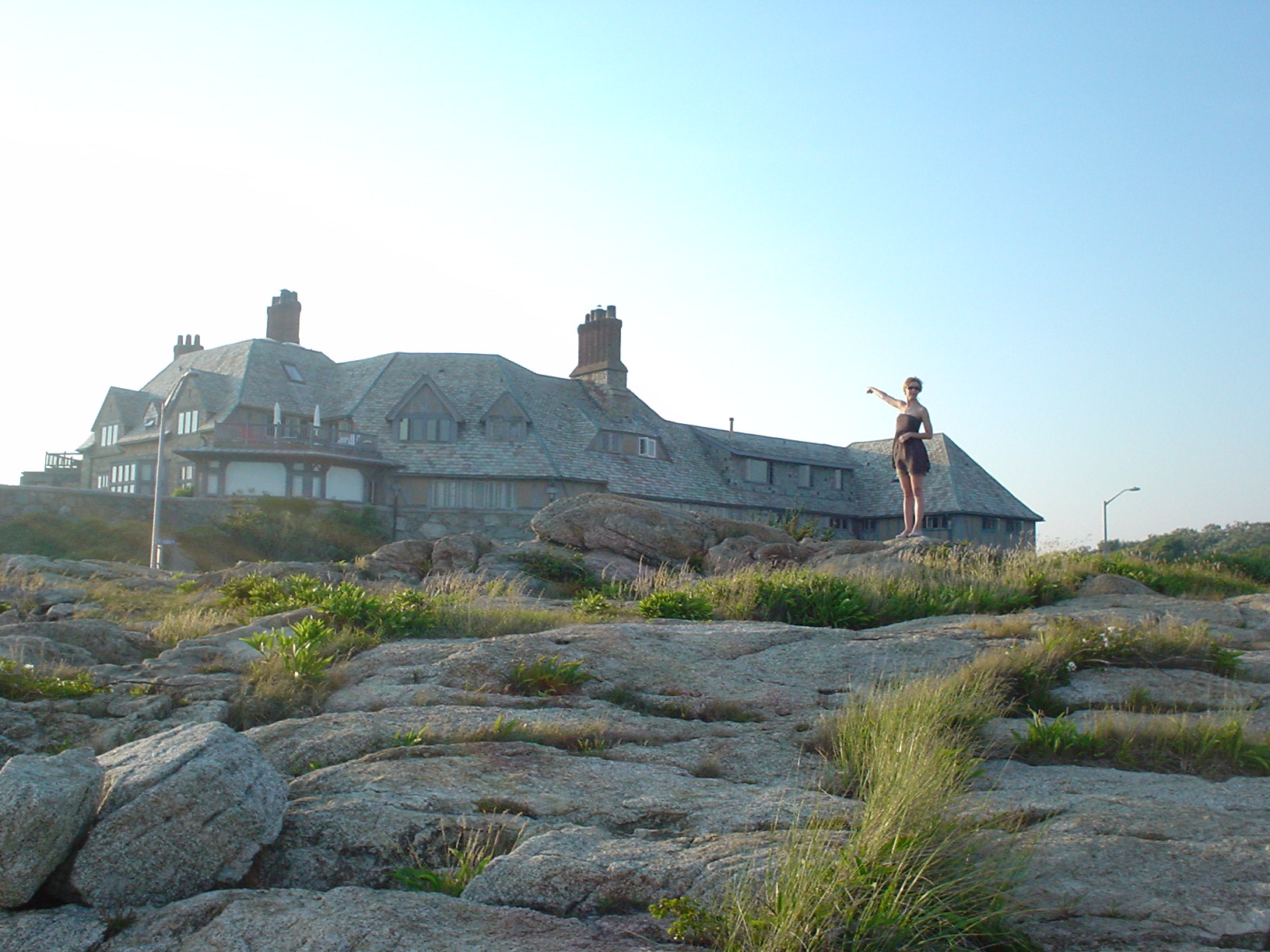 a house in the middle of a field with rocks