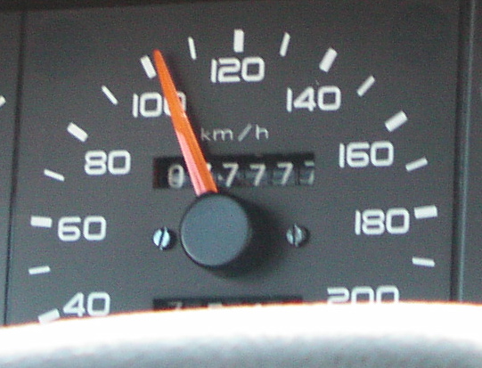 the dashboard of a vehicle with an arrow at the center