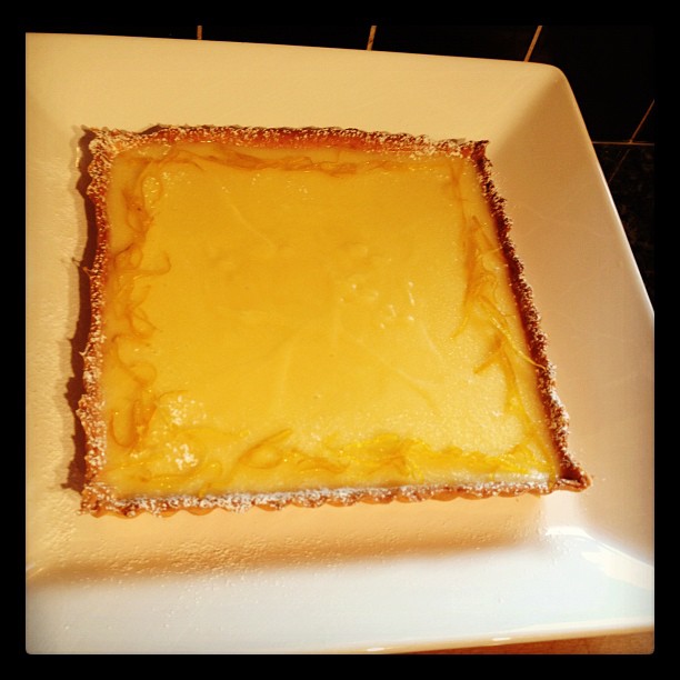 a cheese covered cake on top of a white plate