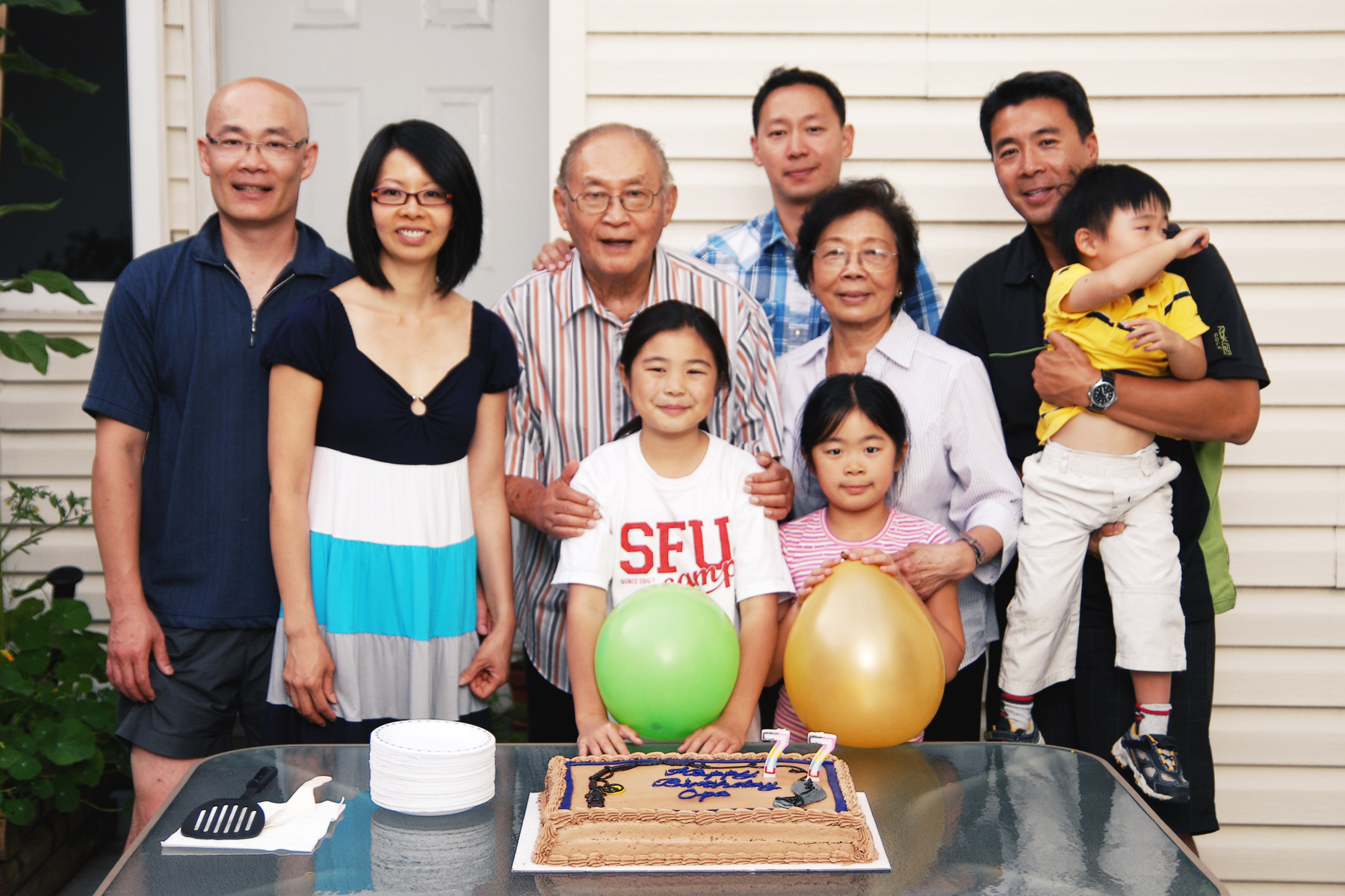 a family celetes their birthday with a birthday cake