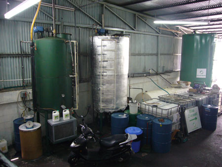 an industrial building filled with blue tanks and a motorcycle