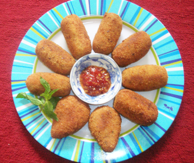 several breaded food on a blue and white plate
