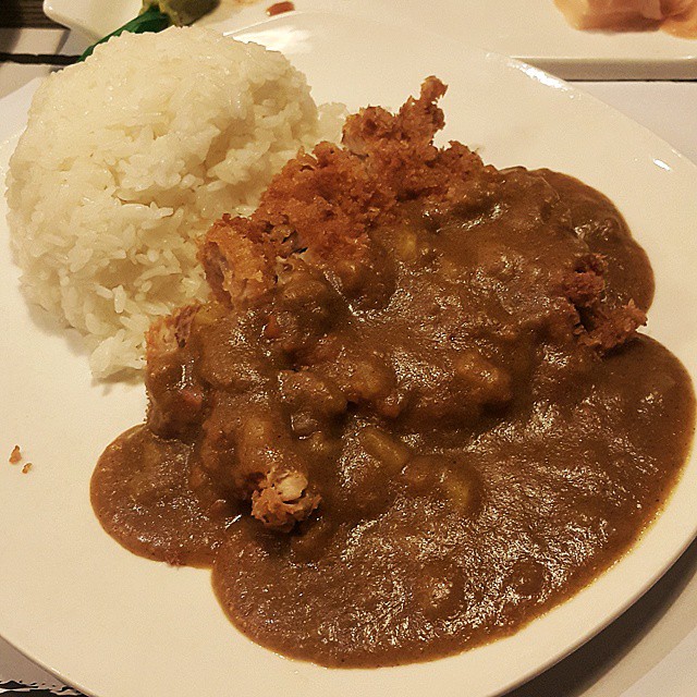 the dinner plate has mashed meat and a side of white rice