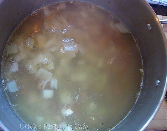 a stew is in a large pot on a stove