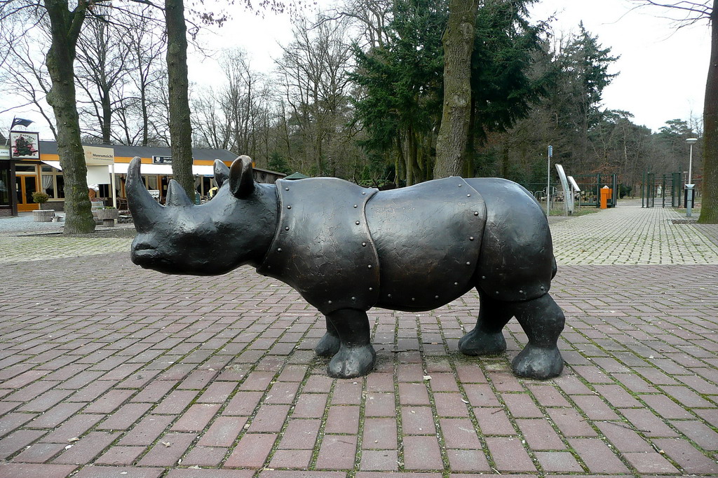 the bronze sculpture depicts a rhino standing with its head turned backwards