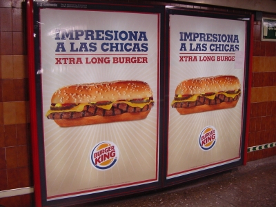 two large signs with an advertit for cheeseburgers