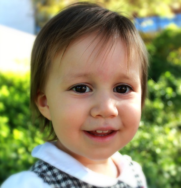 a close up of a small child smiling