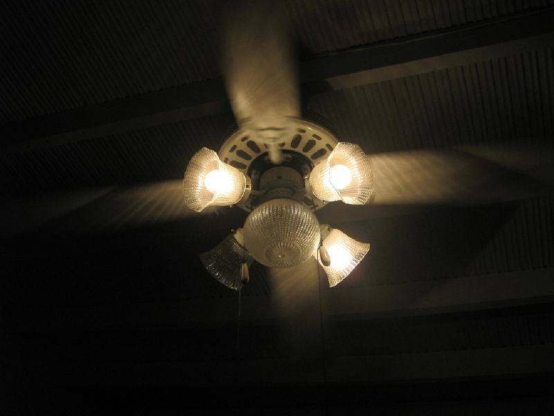 an image of a ceiling fan with lamps on it