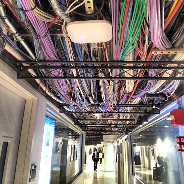 this is a very colorful ceiling with many wires hanging from it