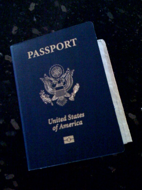 a blue passport with a united states flag on top