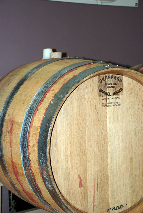 four wooden barrels sit next to each other
