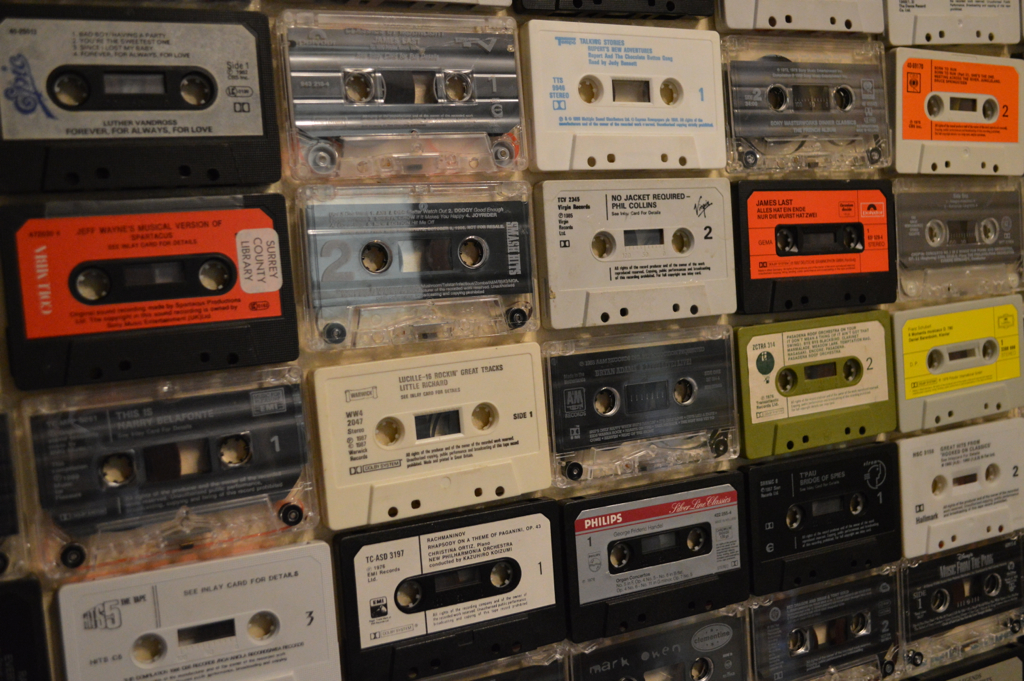 several floppy recorders are arranged against a wall in rows