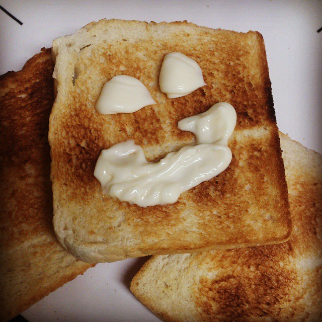 toast with icing on top of it in the shape of a face