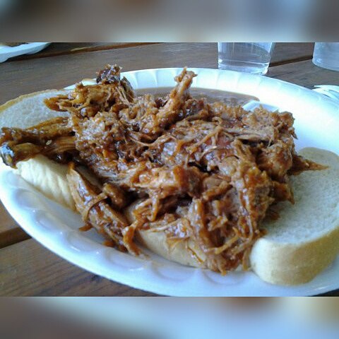 a plate with pulled pork on bread