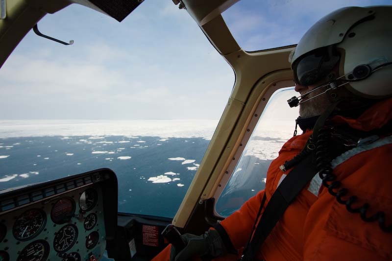 a person in a helicopter looking out the window