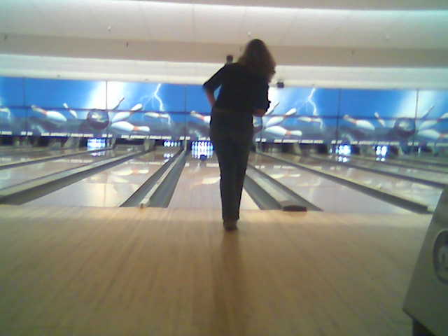 woman standing at the bowling alley with her hand on hips