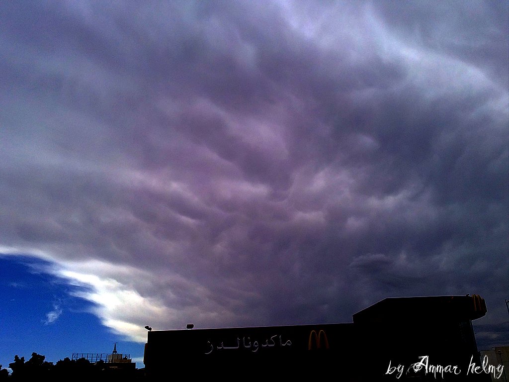 storm clouds loom over a black building