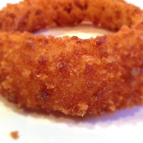 a fried doughnut ring sitting on a table