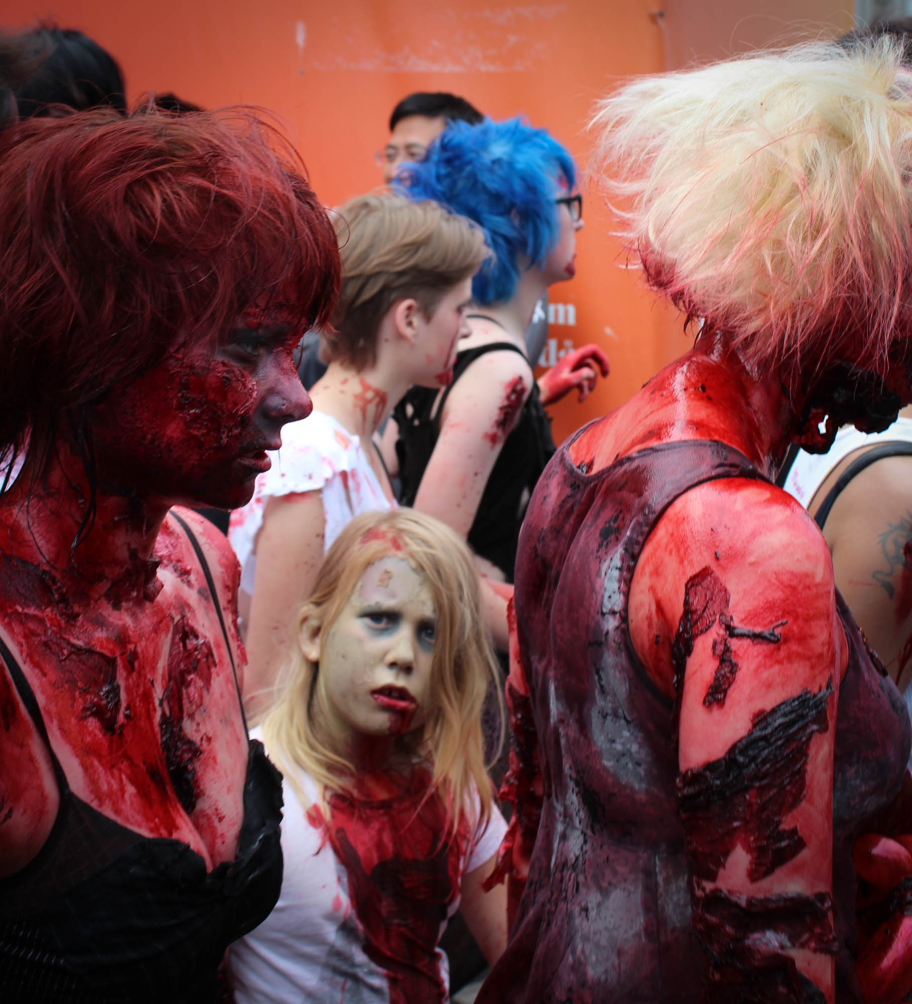 a group of people covered in red, white and black paint