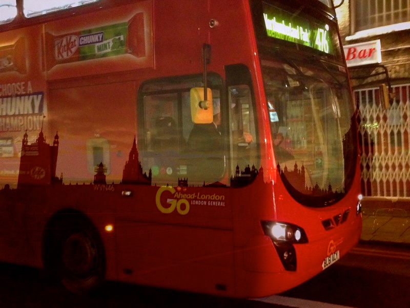 a red bus stopped with an open top