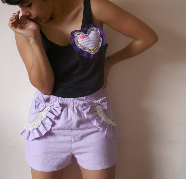 a girl wearing pink shorts with white hearts