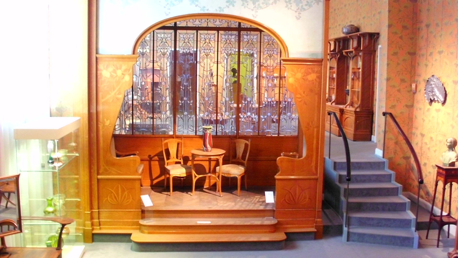 an entryway with two chairs and a staircase in a home