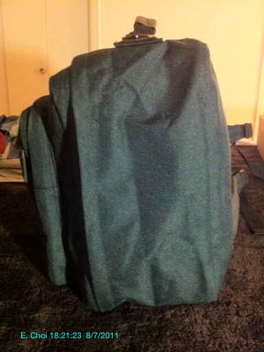 the back of a suit case on a bed