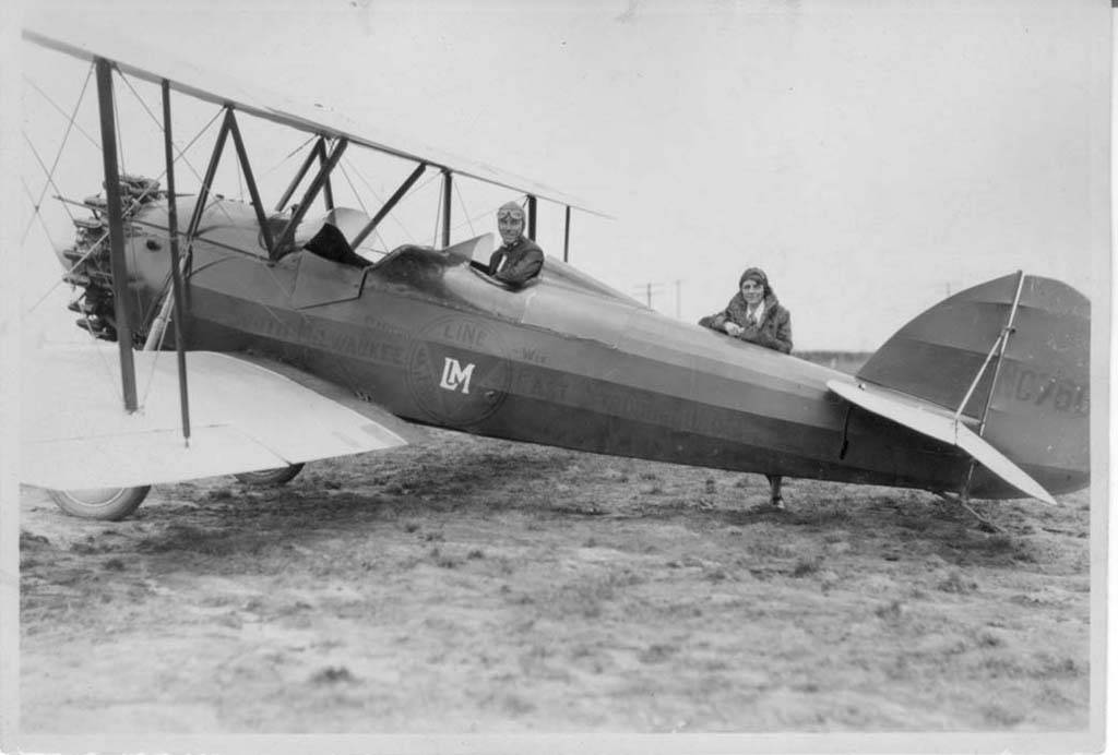 a small airplane with two women riding in it