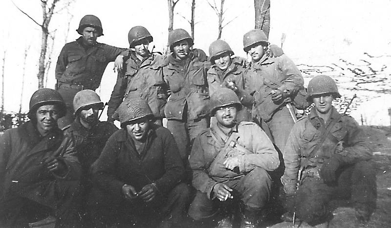 a group of men in full military uniforms posing for a picture