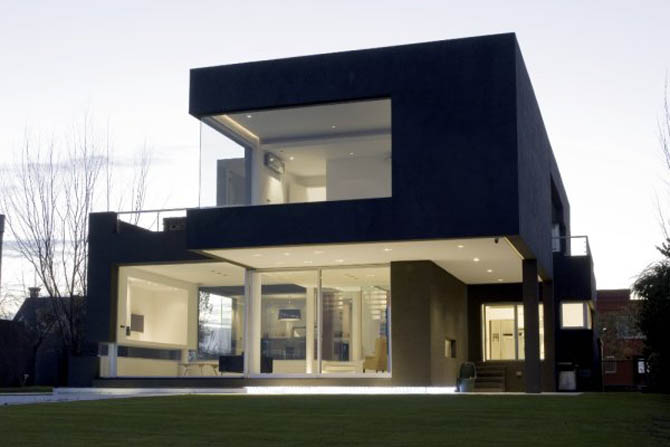 a modern house is lit up at night