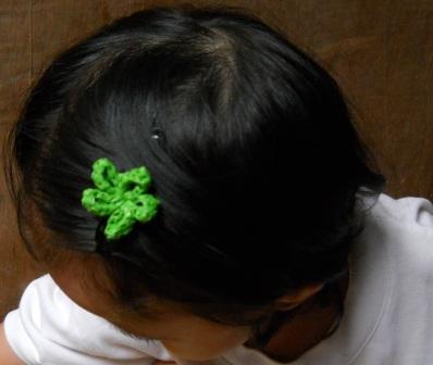 the  is wearing green flower clips